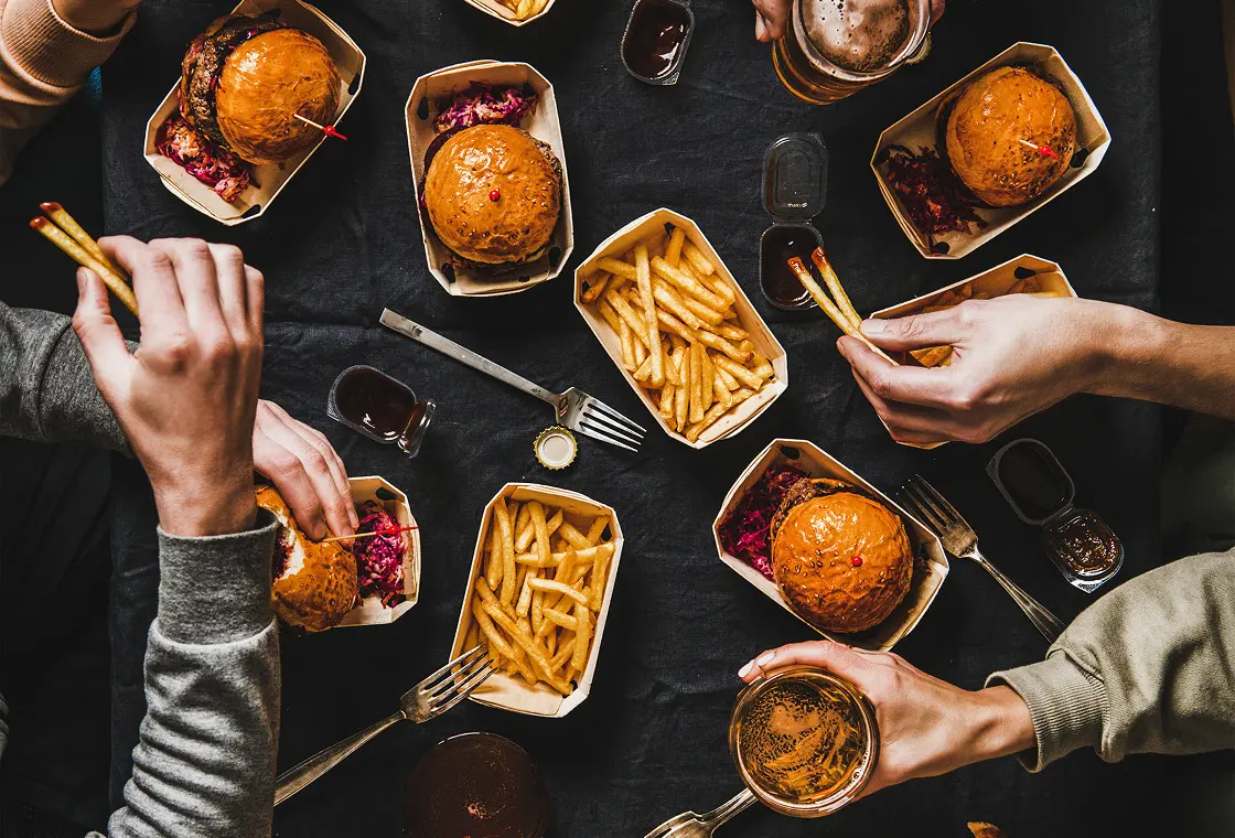 Friends enjoying fast food meal